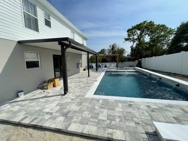 Pergola and paver deck beside the pool