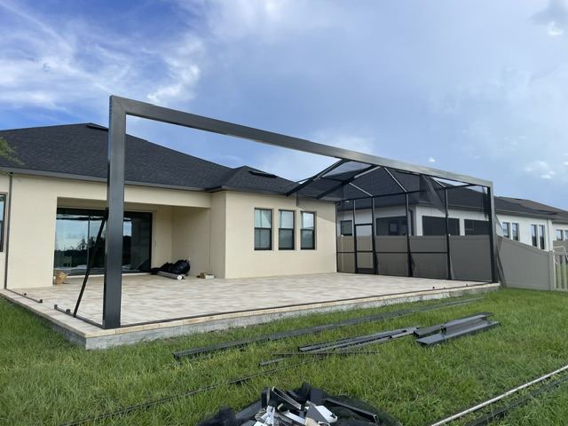 Aluminum pergola frame going up over a patio