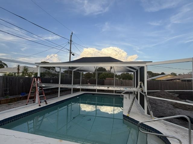 Pool enclosure framing over pool